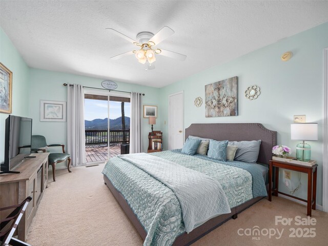 364 Blevins Knob Dr, Burnsville, NC 28714 - carpeted bedroom with a ceiling fan, access to outside, a mountain view, and a textured ceiling