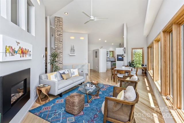 212 Chestnut Forest Rd, Fairview, NC 28730 - living area with light wood-type flooring, high vaulted ceiling, a ceiling fan, a glass covered fireplace, and recessed lighting