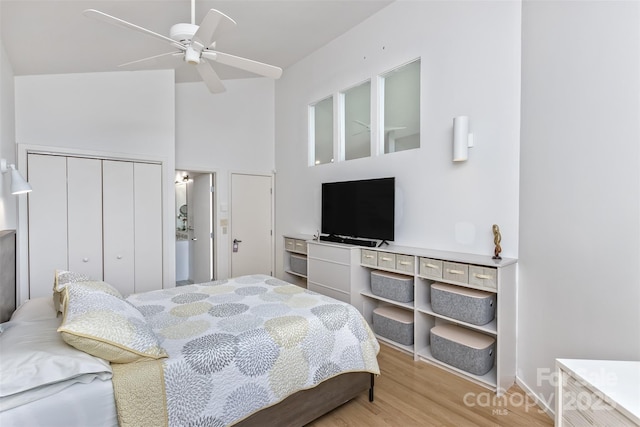 212 Chestnut Forest Rd, Fairview, NC 28730 - bedroom with high vaulted ceiling, a closet, light wood-style floors, ceiling fan, and baseboards