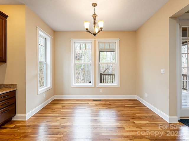 unfurnished dining area with a healthy amount of sunlight and light wood finished floors