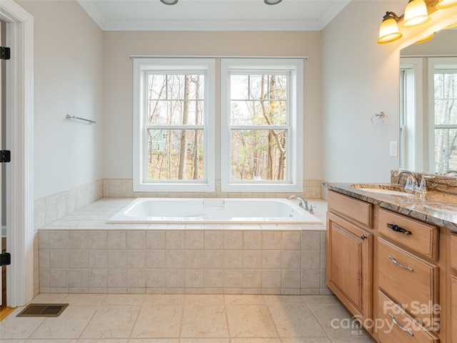 full bathroom featuring a garden tub, crown molding, vanity, and visible vents
