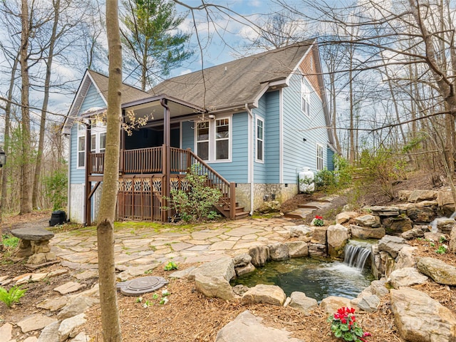 bungalow with a small pond, stairway, crawl space, and a shingled roof