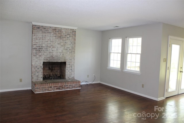 9915 Lottie Ln, Charlotte, NC 28262 - unfurnished living room with baseboards, a fireplace, wood finished floors, and a textured ceiling