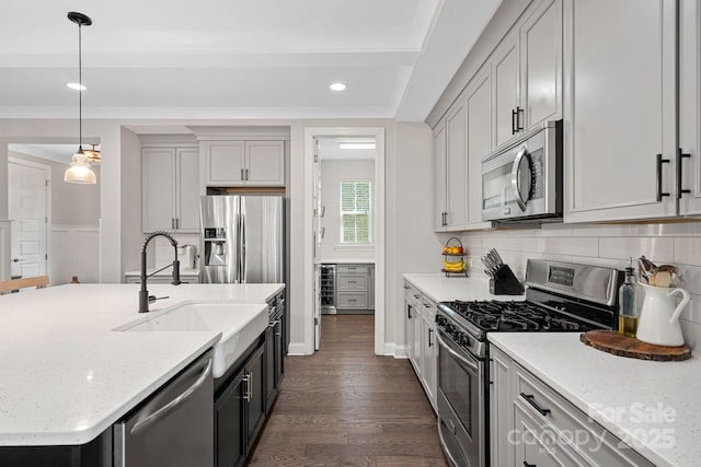 4195 Island Fox Ln, Denver, NC 28037 - kitchen with dark wood finished floors, stainless steel appliances, backsplash, a sink, and decorative light fixtures