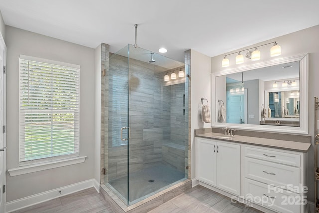 4195 Island Fox Ln, Denver, NC 28037 - bathroom with a shower stall, a healthy amount of sunlight, vanity, and baseboards