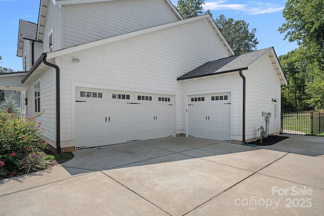 4195 Island Fox Ln, Denver, NC 28037 - view of side of home featuring roof with shingles, concrete driveway, and fence