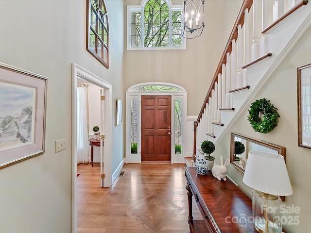 2313 Beechwood Dr, Waxhaw, NC 28173 - foyer entrance featuring a high ceiling, a chandelier, stairway, and baseboards