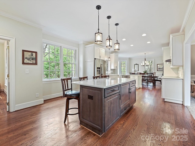 2313 Beechwood Dr, Waxhaw, NC 28173 - kitchen with stainless steel fridge, white cabinetry, light countertops, a kitchen island, and dark wood-style floors