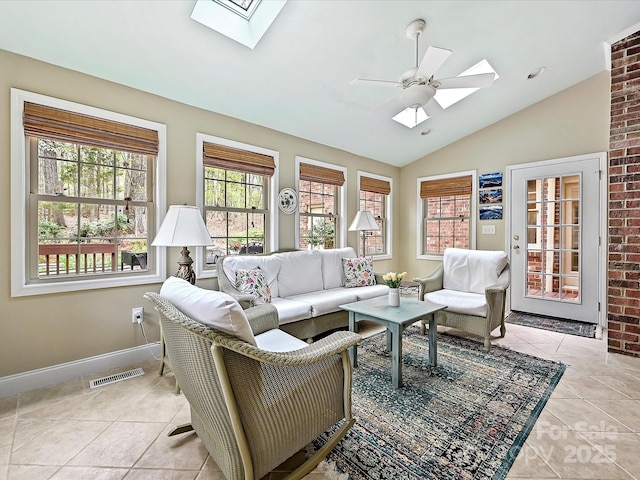 2313 Beechwood Dr, Waxhaw, NC 28173 - living area with a skylight, light tile patterned flooring, vaulted ceiling, baseboards, and ceiling fan