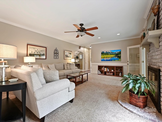 2313 Beechwood Dr, Waxhaw, NC 28173 - living room with carpet flooring, ornamental molding, ceiling fan, a fireplace, and arched walkways