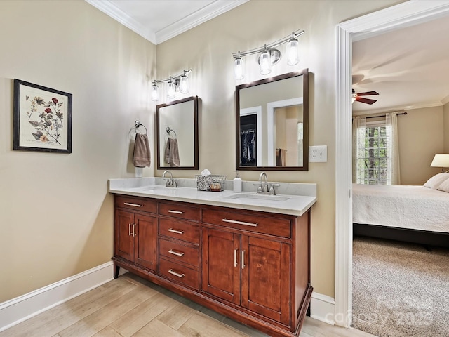 2313 Beechwood Dr, Waxhaw, NC 28173 - ensuite bathroom with ornamental molding, baseboards, double vanity, wood finished floors, and ceiling fan