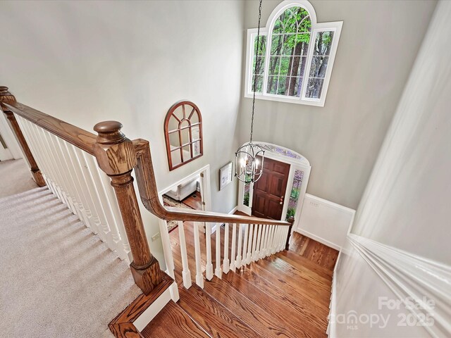 2313 Beechwood Dr, Waxhaw, NC 28173 - staircase featuring wood finished floors and a chandelier