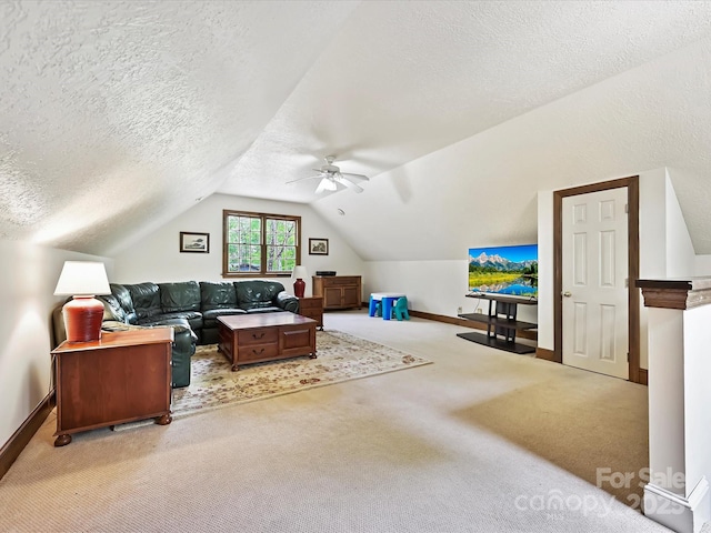 2313 Beechwood Dr, Waxhaw, NC 28173 - carpeted living area featuring ceiling fan, vaulted ceiling, baseboards, and a textured ceiling