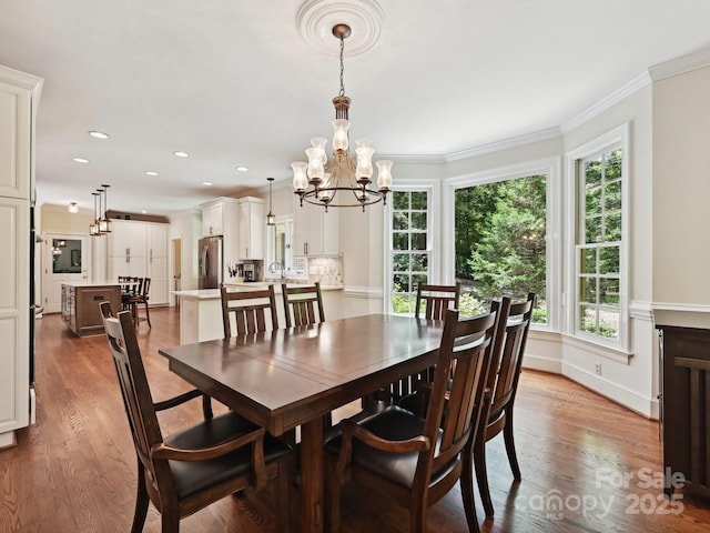 2313 Beechwood Dr, Waxhaw, NC 28173 - dining space with dark wood finished floors, a chandelier, plenty of natural light, ornamental molding, and recessed lighting