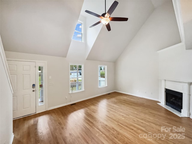 4222 Mt Gallant Rd, Rock Hill, SC 29732 - unfurnished living room featuring a fireplace with flush hearth, visible vents, baseboards, a ceiling fan, and light wood-type flooring