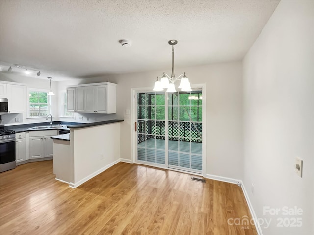 4222 Mt Gallant Rd, Rock Hill, SC 29732 - kitchen featuring white cabinetry, a sink, dark countertops, and appliances with stainless steel finishes