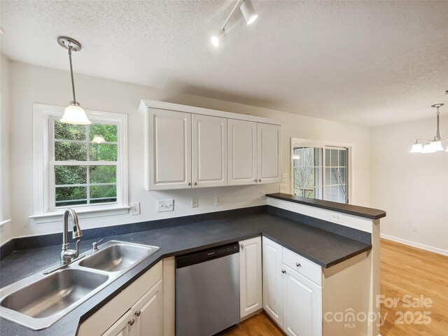 4222 Mt Gallant Rd, Rock Hill, SC 29732 - kitchen featuring a sink, white cabinetry, a peninsula, stainless steel dishwasher, and dark countertops