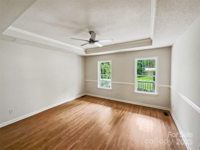 4222 Mt Gallant Rd, Rock Hill, SC 29732 - spare room with a raised ceiling, wood finished floors, a textured ceiling, visible vents, and ceiling fan
