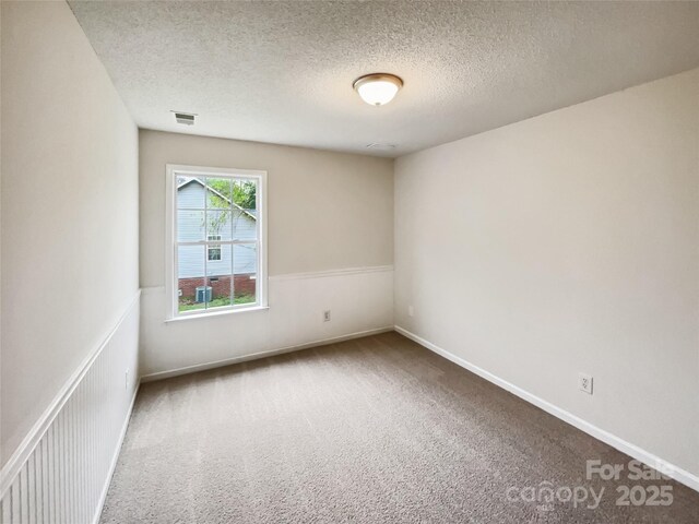 4222 Mt Gallant Rd, Rock Hill, SC 29732 - carpeted spare room featuring wainscoting, a textured ceiling, baseboards, and visible vents