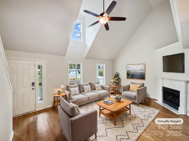 4222 Mt Gallant Rd, Rock Hill, SC 29732 - living room with a ceiling fan, a fireplace with flush hearth, a high ceiling, wood finished floors, and baseboards