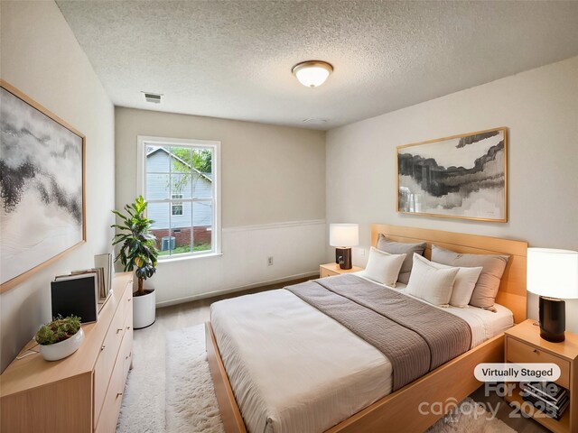4222 Mt Gallant Rd, Rock Hill, SC 29732 - bedroom featuring carpet floors, a textured ceiling, visible vents, and a wainscoted wall