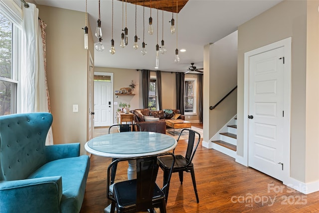 dining area featuring baseboards, recessed lighting, stairs, ceiling fan, and wood finished floors