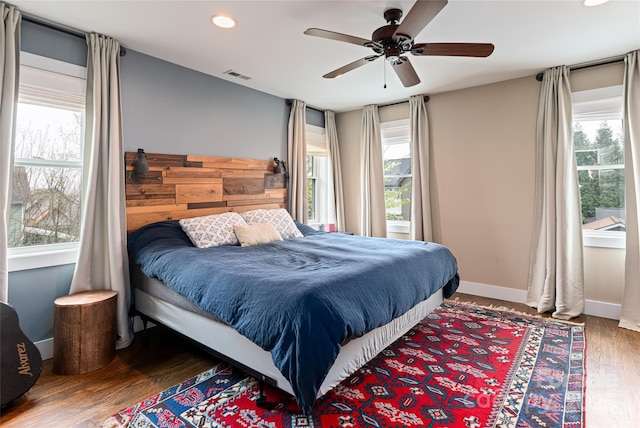 bedroom with visible vents, baseboards, a ceiling fan, recessed lighting, and wood finished floors