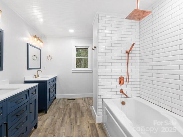 373 Vineyard Rd, Tryon, NC 28782 - full bath with vanity, wood finished floors, baseboards, a combined bath / shower with rainfall shower, and recessed lighting