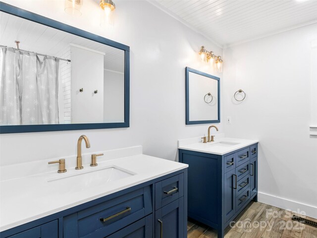 373 Vineyard Rd, Tryon, NC 28782 - full bath featuring wood finished floors, two vanities, wooden ceiling, and baseboards