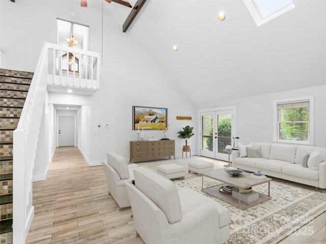 373 Vineyard Rd, Tryon, NC 28782 - living room featuring high vaulted ceiling, light wood finished floors, stairway, a skylight, and french doors