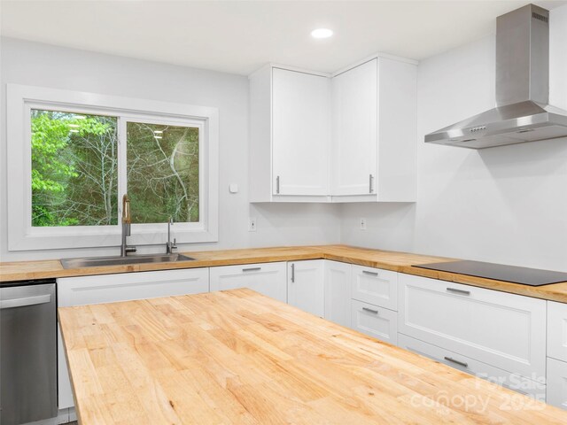 373 Vineyard Rd, Tryon, NC 28782 - kitchen featuring butcher block countertops, wall chimney exhaust hood, a sink, stainless steel dishwasher, and black electric cooktop