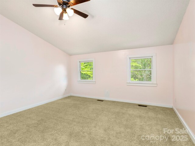 373 Vineyard Rd, Tryon, NC 28782 - spare room with vaulted ceiling, carpet floors, ceiling fan, and baseboards