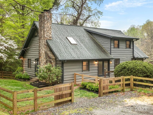 373 Vineyard Rd, Tryon, NC 28782 - view of front of house featuring a shingled roof and a chimney