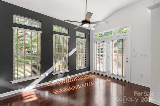 interior space featuring wood finished floors, baseboards, a ceiling fan, and vaulted ceiling