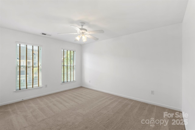 unfurnished room with light carpet, ceiling fan, and baseboards