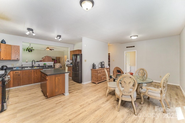 dining area with a ceiling fan, baseboards, light wood finished floors, and visible vents