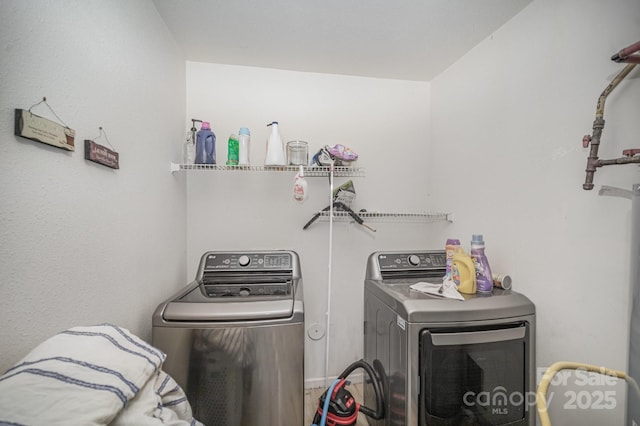 clothes washing area with laundry area and washer and dryer