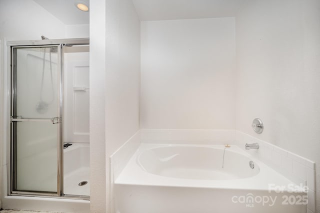 full bathroom with a bath and a shower stall