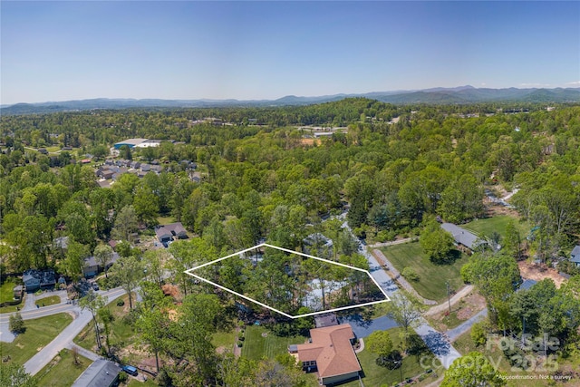 bird's eye view featuring a wooded view