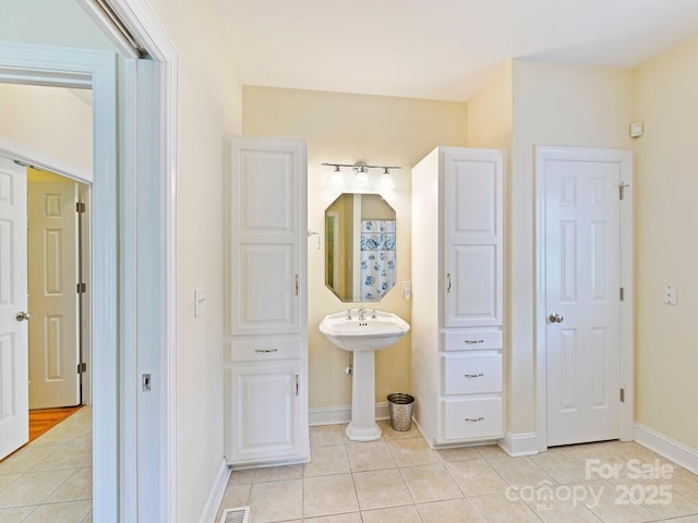 bathroom featuring baseboards and tile patterned flooring