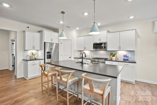 13709 Roderick Dr Unit 193, Huntersville, NC 28078 - kitchen featuring a kitchen bar, a sink, dark countertops, premium appliances, and backsplash