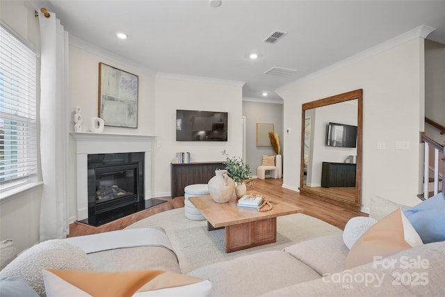 13709 Roderick Dr Unit 193, Huntersville, NC 28078 - living room featuring crown molding, a glass covered fireplace, visible vents, recessed lighting, and wood finished floors