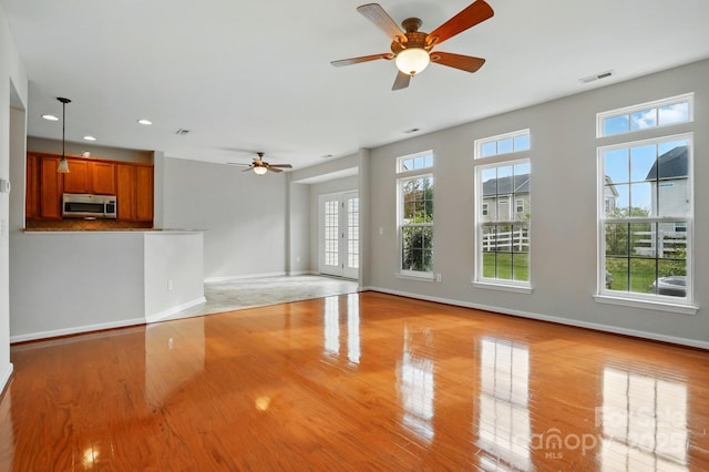 125 Snead Rd Unit 60, Fort Mill, SC 29715 - unfurnished living room with a healthy amount of sunlight, light wood-type flooring, baseboards, and a ceiling fan