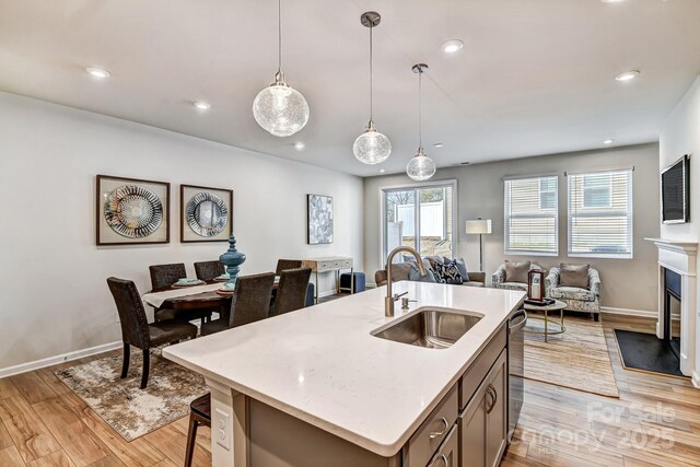 8038 Downy Oak Ln, Charlotte, NC 28269 - kitchen featuring open floor plan, decorative light fixtures, recessed lighting, a sink, and light wood-style flooring