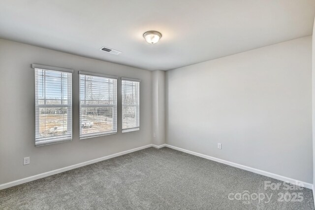 8042 Downy Oak Ln, Charlotte, NC 28269 - spare room with baseboards, visible vents, and carpet