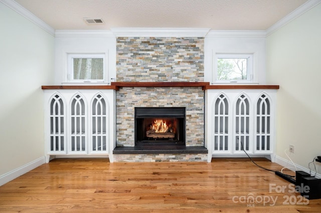 51 Sugar Hill Dr, Weaverville, NC 28787 - unfurnished living room featuring a stone fireplace, wood finished floors, baseboards, ornamental molding, and visible vents