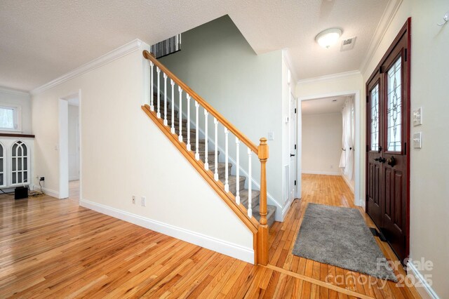 51 Sugar Hill Dr, Weaverville, NC 28787 - foyer with hardwood / wood-style floors, visible vents, crown molding, baseboards, and stairs