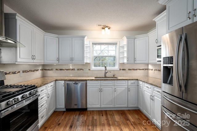 51 Sugar Hill Dr, Weaverville, NC 28787 - kitchen with stainless steel appliances, visible vents, wall chimney range hood, a sink, and a textured ceiling