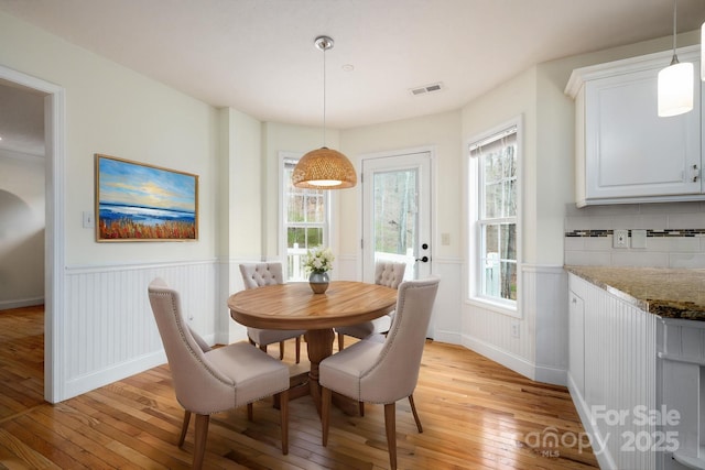 51 Sugar Hill Dr, Weaverville, NC 28787 - dining space featuring light wood-style flooring, visible vents, and a wainscoted wall