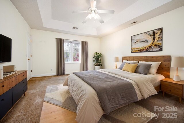 51 Sugar Hill Dr, Weaverville, NC 28787 - bedroom featuring baseboards, a tray ceiling, visible vents, and light wood-style floors